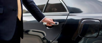 Businessman going inside his car