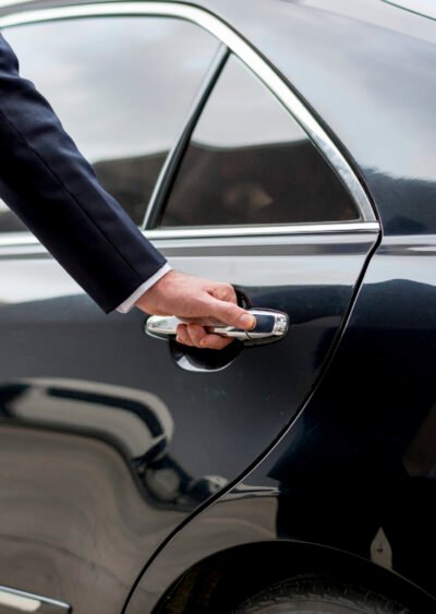 Businessman going inside his car